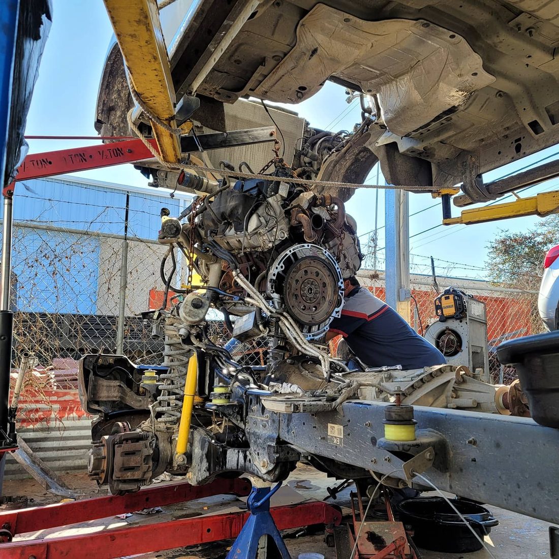 A mechanic working on an engine pulled for repair